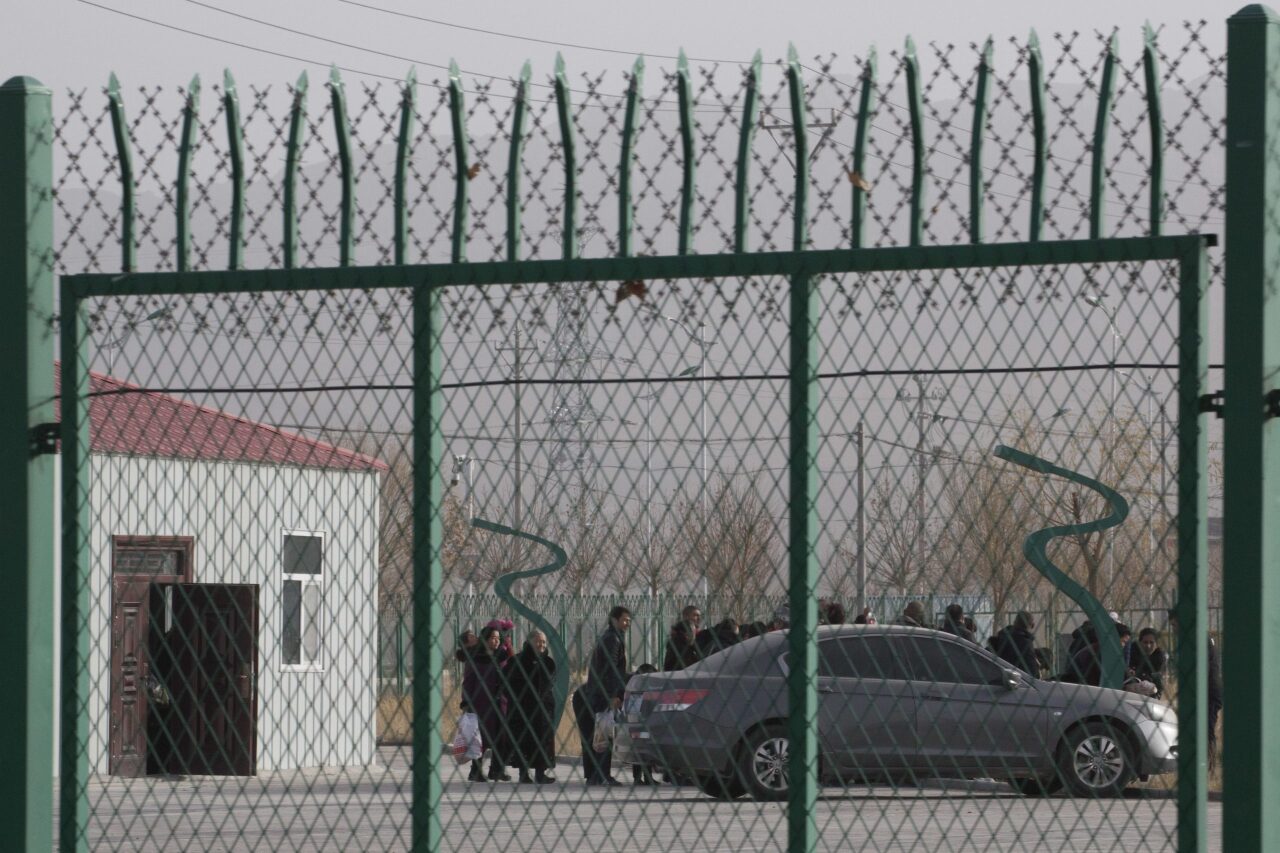 In this Monday, Dec. 3, 2018, photo, residents line up inside the Artux City Vocational Skills Education Training Service Center at the Kunshan Industrial Park in Artux in western China's Xinjiang region. Across the Xinjiang region, a growing number of internment camps have been built, where by some estimates 1 million Muslims are detained, forced to give up their language and their religion and subject to political indoctrination. Now, the Chinese government is also forcing some detainees to work in manufacturing and food industries. Some of them are within the internment camps; others are privately owned, state-subsidized factories where detainees are sent once they are released. (AP Photo/Ng Han Guan)